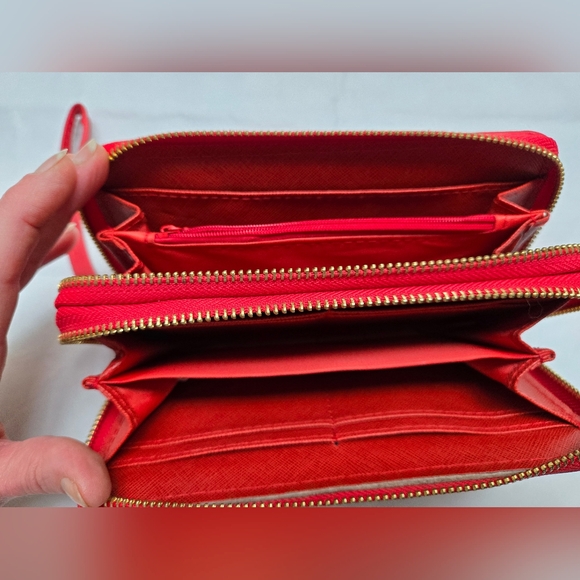 Red wallet with 2 zipper compartments and a wrist handle. - Picture 9 of 12